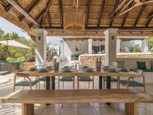 an outdoor dining area with a table and chairs at Farmhouse in Ibiza with Bali Pavilion in Santa Gertrudis de Fruitera
