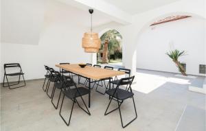 a dining room with a wooden table and chairs at Nice Home In Zdrelac With Sauna in Ždrelac