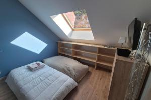 a bedroom with a bean bag bed and a window at Appartement 4 personnes avec accès piscine in La Féclaz