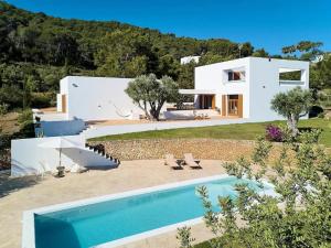 a villa with a swimming pool and a house at Villa in San Carlos near Aguas Blancas Beach in Sant Carles de Peralta