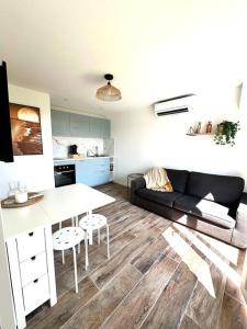 a living room with a couch and a table at T2 niché entre mer et montagne in Ollioules