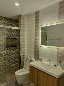 a bathroom with a toilet and a sink at 1 Bed Room Suite Elysium Tower-Opposite Centaurus Mall Islamabad in Islamabad