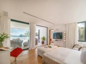 a bedroom with a large bed and a large window at Villa in Ibiza near Salinas Beach in Sant Llorenç de Balafia +32 photos