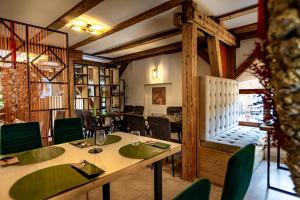 a dining room with a table and chairs at Wanderer Sighisoara in Sighişoara