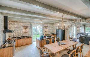 a kitchen with a wooden table and a dining room at Villa Elena in Rovinj