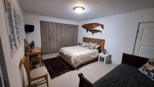a bedroom with a bed and a chair in it at Budget Boutique in Blomtuin