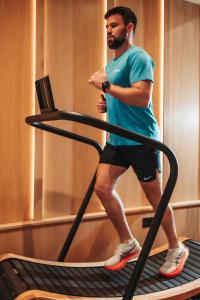 a man walking on a treadmill in a gym at The Scotsman Hotel in Edinburgh