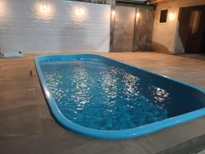 a blue tub filled with water in a room at Casa para Veraneio em Torres in Torres