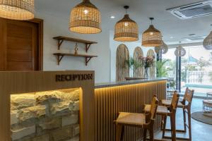 a restaurant with a table and chairs and pendant lights at Sunny Aparts 2 in Canggu