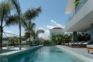 a swimming pool in the middle of a house at Sunny Aparts 2 in Canggu