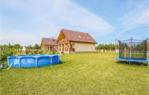 a yard with a house and a basketball hoop at 3 Bedroom Beautiful Home In Mscicie in Podamirowo +20 photos