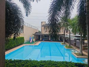a large blue swimming pool in front of a building at Casa Prian in Manila