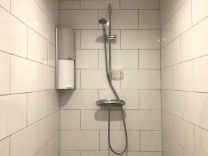 a shower with a shower head in a bathroom at 4 person holiday home in Frändefors in Frändefors +28 photos