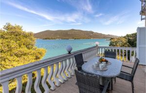 a table on a balcony with a view of the water at Stunning Home In Ston With Sauna in Ston