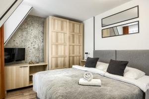 Posteľ alebo postele v izbe v ubytovaní Przytulia Apartamenty i Pokoje