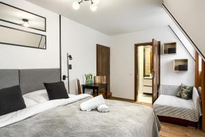 Posteľ alebo postele v izbe v ubytovaní Przytulia Apartamenty i Pokoje