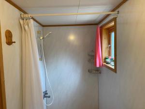a bathroom with a shower with a shower curtain at 8 person holiday home in Svensby in Svensby +38 photos