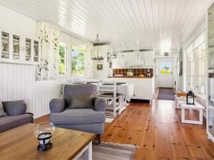 a kitchen and living room with a table and chairs at 4 person holiday home in LÖTTORP in Löttorp