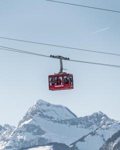 a ski lift with people on it flying over a mountain at Coeur de Megève in Megève