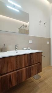 a bathroom with a sink and a mirror at Lacugnano Apartment La tua casa in umbria in Perugia