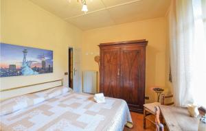 a bedroom with a bed and a wooden cabinet at Casa Le Vallette in Massarosa