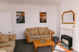 a living room with a couch and a coffee table at Dream Beach View in Weymouth