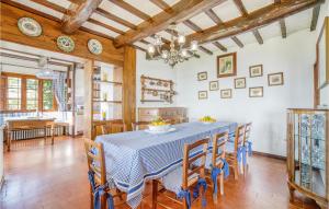 a dining room with a blue table and chairs at Villa I Cedri in Santa Lucia