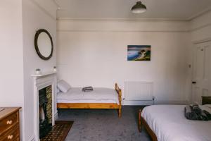 a bedroom with two beds and a fireplace at Dream Beach View in Weymouth