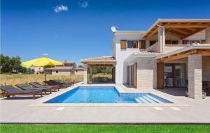 a villa with a swimming pool and a house at Villa Fortuna in Funtana