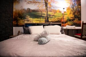 a bedroom with a bed with towels on it at LL Villa Sanandrei in Sânandrei