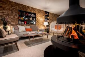 a living room with a couch and a fireplace at Coeur de Megève in Megève
