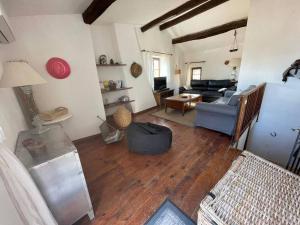 a living room with a couch and a table at Maison de Village in Péret