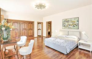 a bedroom with a bed and a table and chairs at Villa Oleandro in Fauglia