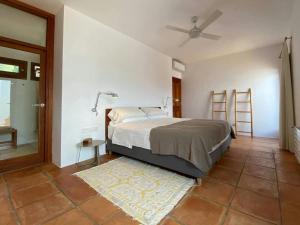 a bedroom with a bed and a ceiling fan at Villa in San Carlos near Aguas Blancas Beach in Sant Carles de Peralta +32 photos