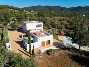 an aerial view of a white house with a swimming pool at Villa in San Carlos near Aguas Blancas Beach in Sant Carles de Peralta