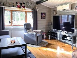 a living room with a large flat screen tv at 4 star holiday home in Fengersfors in Fengersfors