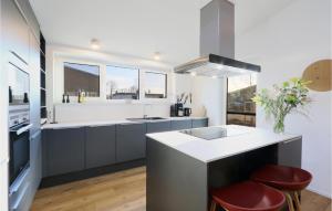 a kitchen with a sink and a counter top at Amazing Home In Lembruchdümmer See in Lembruch