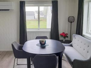 a living room with a table and a couch at 4 person holiday home in Borhaug in Borhaug