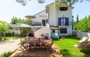 an external view of a house with a table and chairs at Casa Bizzarra in Rovinj