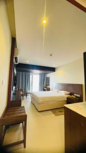 a hotel room with a bed and a window at Resort Sur Beach Holiday in Sur