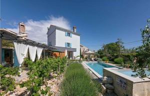 a house with a swimming pool next to a building at Villa Maxima Agri in Poreč