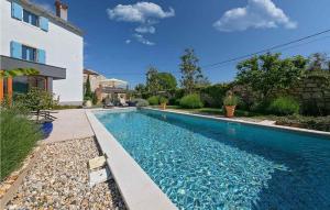 a swimming pool in front of a house at Villa Maxima Agri in Poreč +41 photos