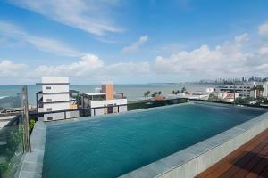 a swimming pool on top of a building with the water at Condomínio Ozean - Bessa in João Pessoa
