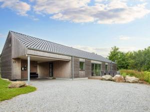 a house with a metal roof on a gravel driveway at 4 star holiday home in Sydals-By Traum in Neder Lysabild