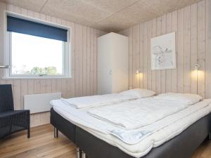 a large bed in a room with a window at 4 star holiday home in Sydals-By Traum in Neder Lysabild