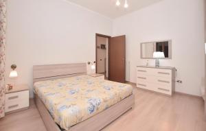 a bedroom with a bed and a dresser and a window at 1 Bedroom Lovely Apartment In Tuscania in Tuscania