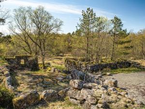 un vecchio muro di pietra in un campo con alberi di 7 person holiday home in lyngdal a Lyngdal