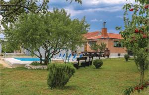 a house with a yard with a swimming pool at Three-Bedroom Holiday Home In Dugogabe in Dugobabe +32 photos