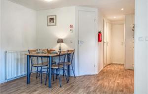 a dining room with a blue table and chairs at 2 Bedroom Gorgeous Home In Heinkenszand in Heinkensand