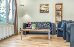 a living room with a couch and a coffee table at 2 Bedroom Gorgeous Home In Heinkenszand in Heinkensand